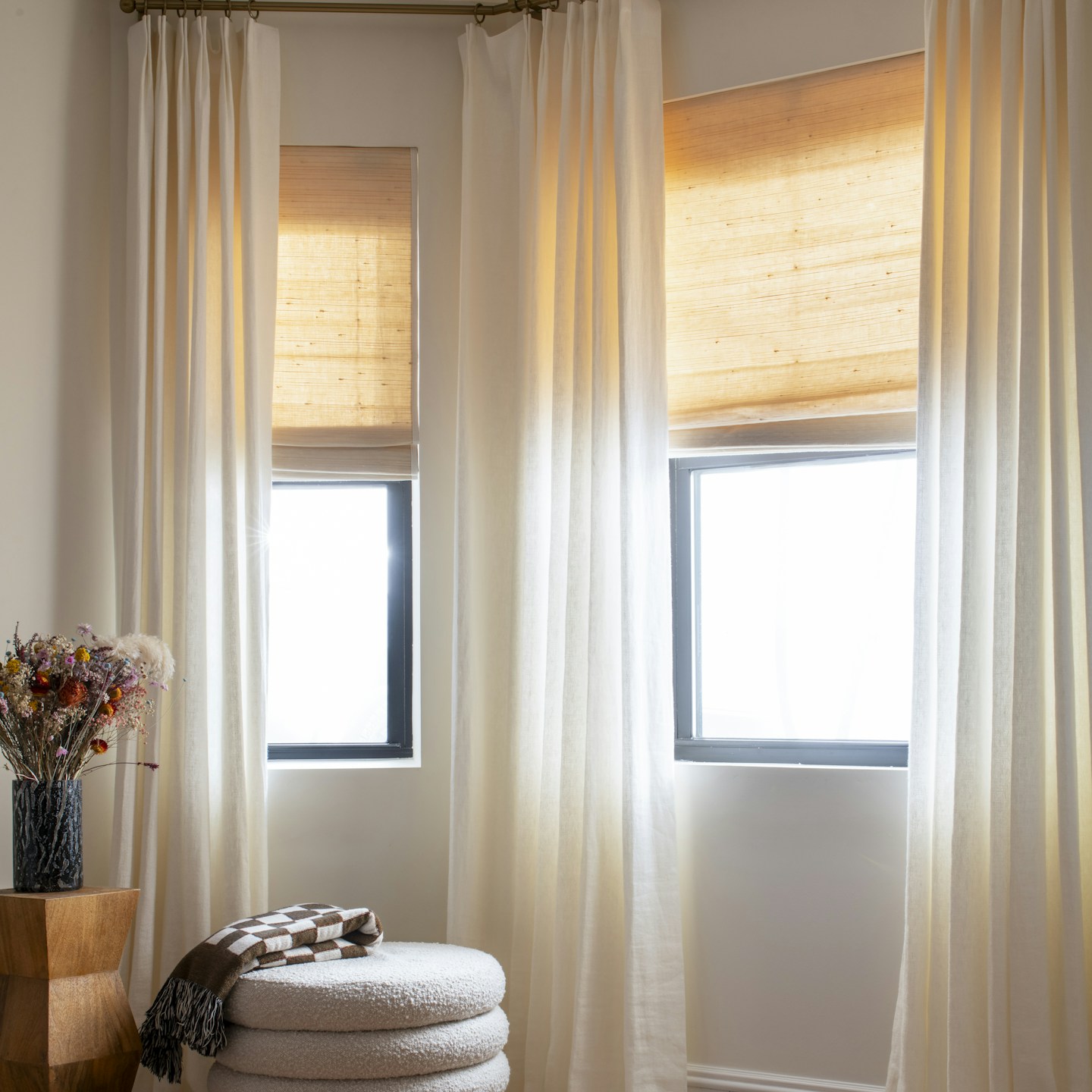 Custom woven wood shades used with custom drapery to reduce energy bills while creating a beautiful atmosphere.